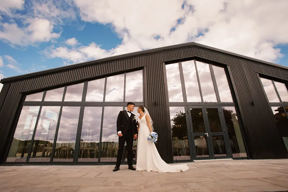 Wedding Couple outside modern wedding barn